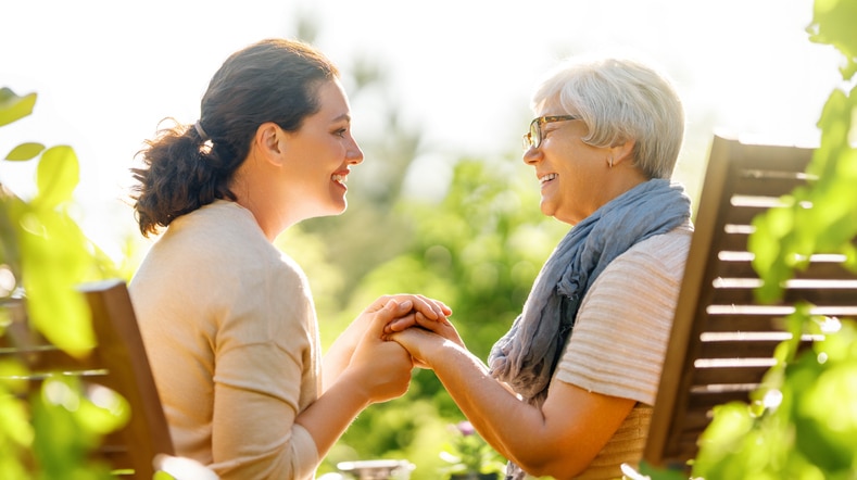 A woman experiences the joy of a career in caregiving as she shares laughter with her client.