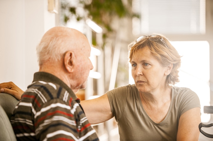 An older man receiving end-of-life care has a serious conversation with his daughter.