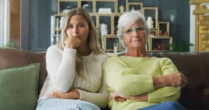A daughter sits patiently with her mother while trying to understand stubbornness in older adults.